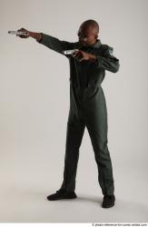 ERIC STANDING POSE WITH GUNS